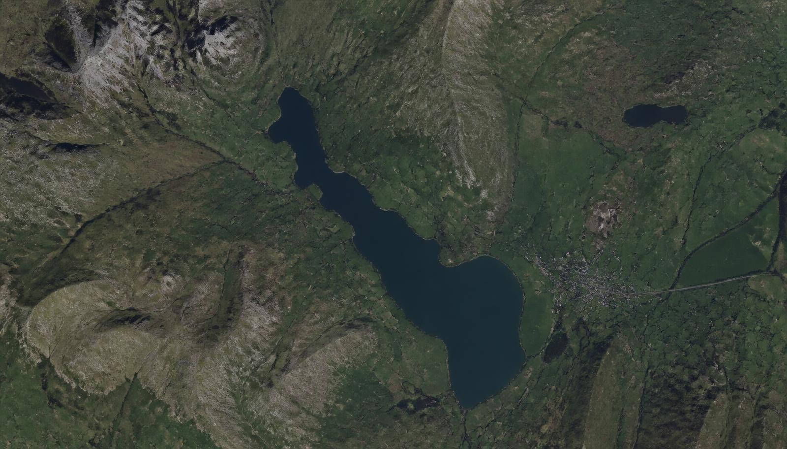 Satellite observation of a landscape with an area of detected surface change outlined