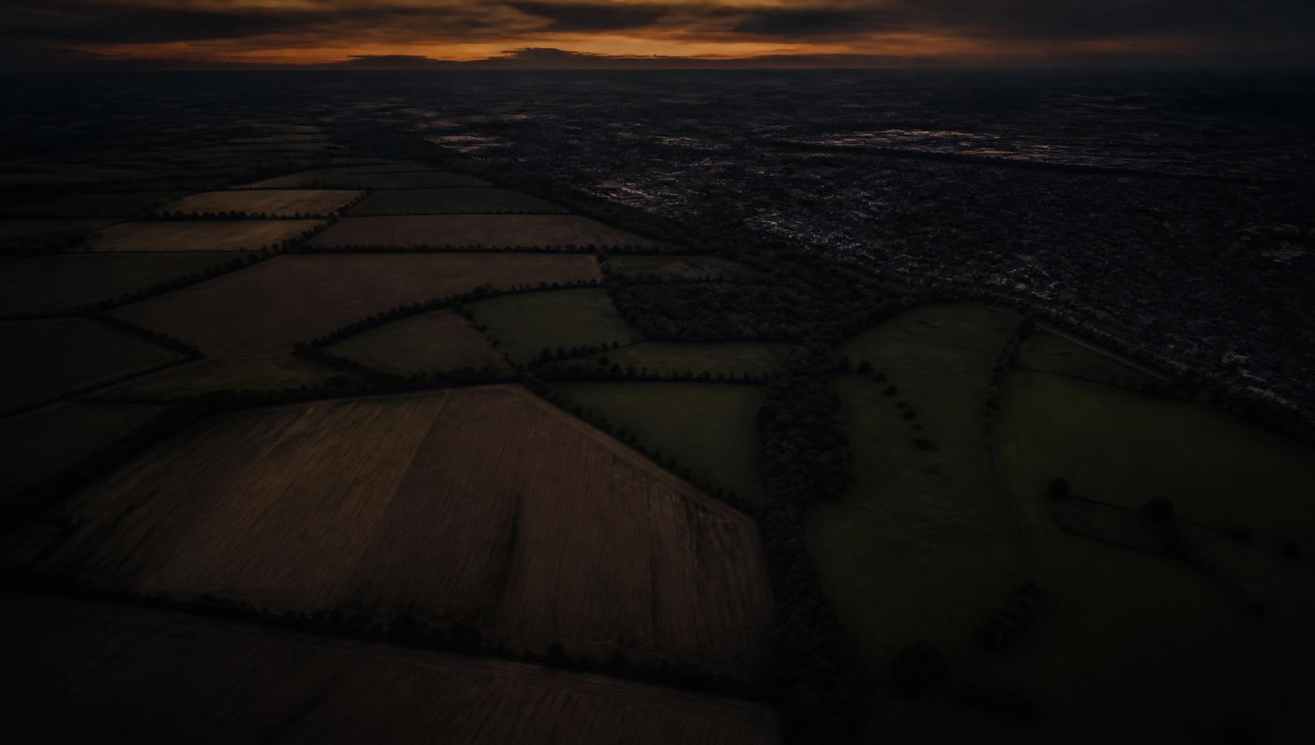 Dusk aerial view of rural and urban fringe land